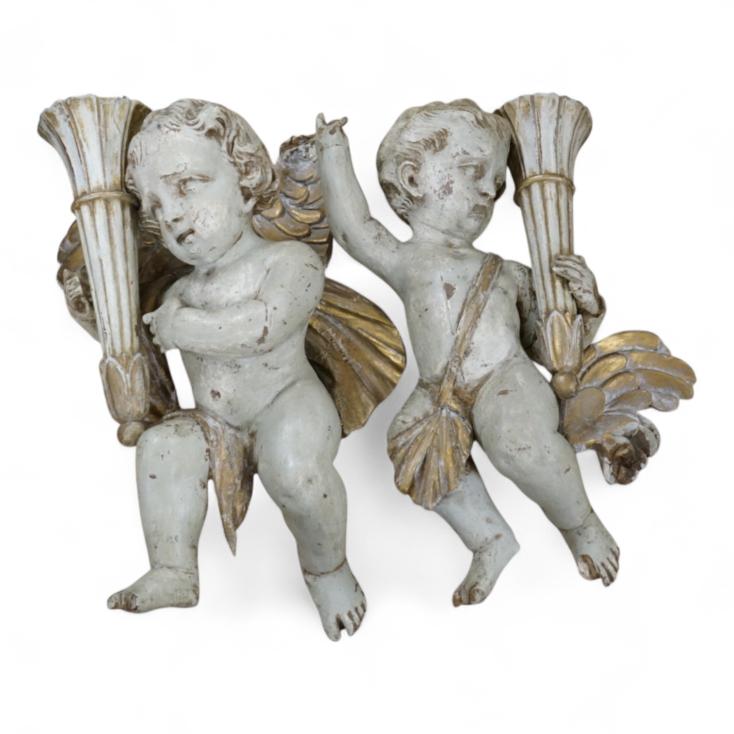 A pair of cream painted and parcel gilt carved wood putti candleholders, 32cm high